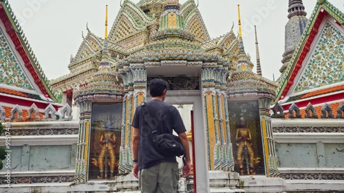 asia travel concept with photographer man see old architecture and pagoda at thailand temple