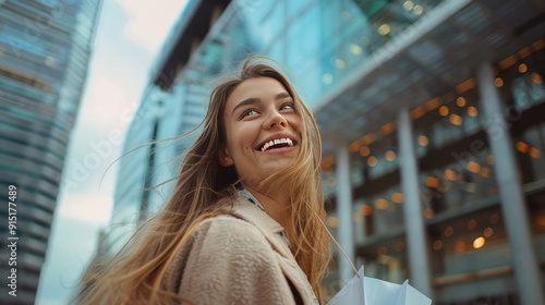 Smiling woman with long hair, holding pastel-colored shopping bags