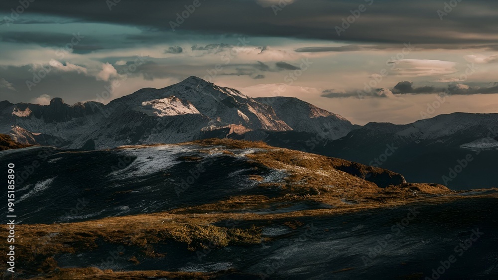 Scenic view of a Mountain with a Snowy Top during Sunset Hours Scenic view of a Mountain with a Snowy Top during Sunset Hours