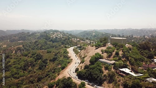 Aerial Shot of Beverly Hills and Bel-Air in Los Angeles, California with Views of Huge Luxurious Houses on the Hills. Slow Panning shot During Sunset photo