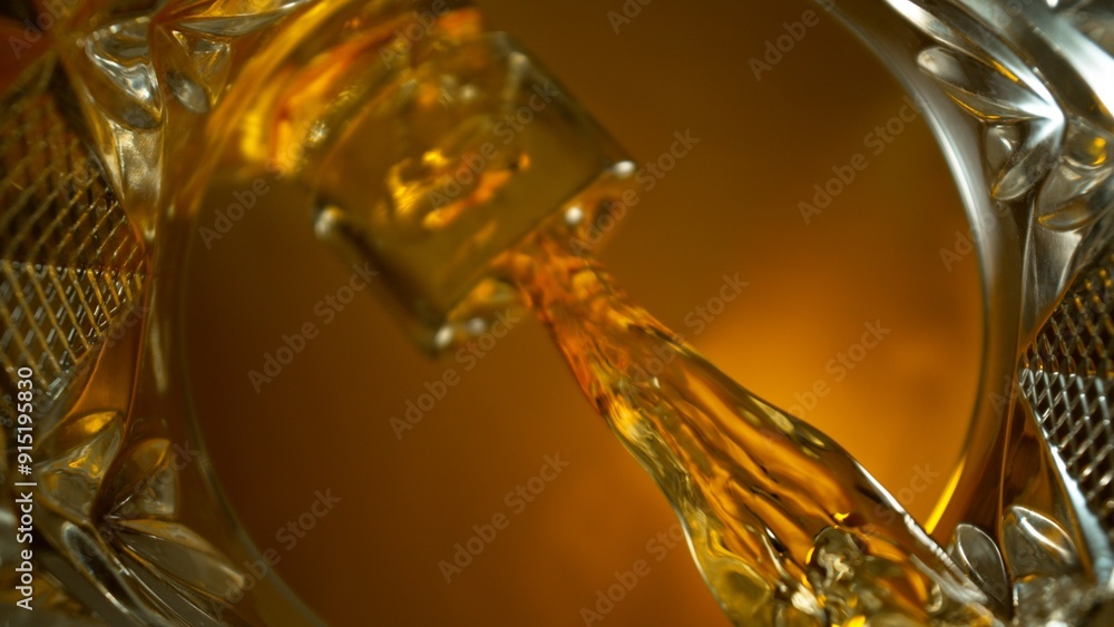Freeze Motion Shot of Whiskey Liquid Pouring, Macro, Unique Angle of View from the Bottom of the Glass Freeze Motion Shot of Whiskey Liquid Pouring, Macro, Unique Angle of View from the Bottom of the Glass
