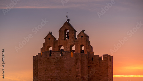 bell tower of saintes maries de la mer at sunset - Camargue - France