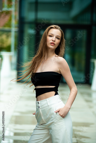  beautiful stylish fashion woman posing near modern building