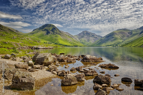 Reflections of the rocks in the clear waters of Wastwater at Wasdale, The Lake District in Cumbria England UK. Scafell Pike in the distance.