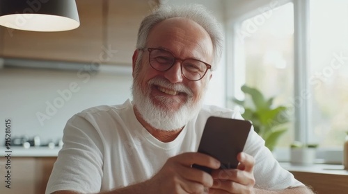 an older man with a beard and glasses is looking at his phone