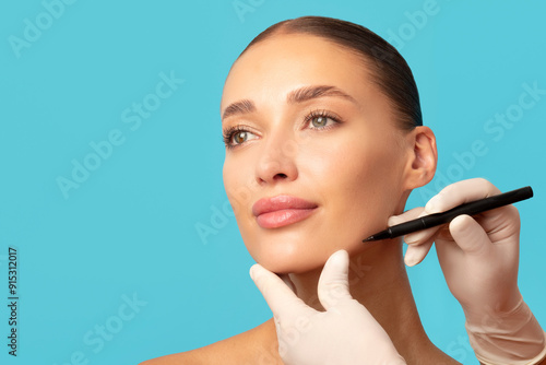 Принти на полотні Plastic surgeon drawing contours with black pen of woman face before surgery, yo