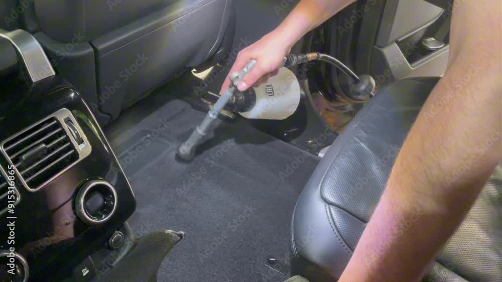 The detailing master cleans the car interior with a hot steam cleaner. Car detailing and the concept of car interior care. Deep washing of car seats with professional equipment. The detailing master cleans the car interior with a hot steam cleaner. Car detailing and the concept of car interior care. Deep washing of car seats with professional equipment.