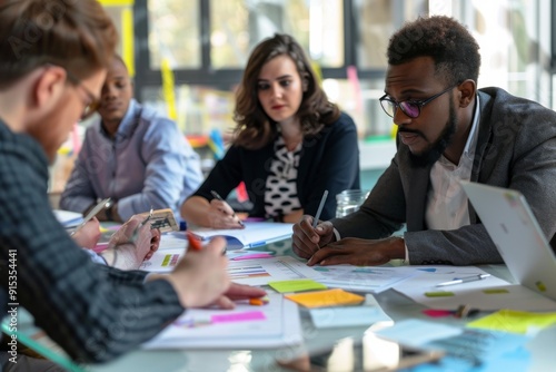 Diverse Team of Professionals Collaborating on a Project in a Modern Office, brainstorming and using sticky notes for Agile methodology