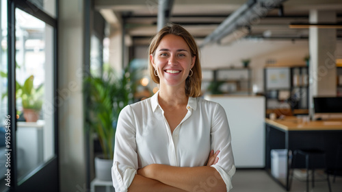Portrait of a smiling female Australian startup founder in their 30s standing in a modern office interior