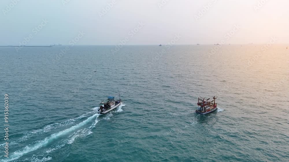 Fishing boat in the ocean for catching fish all a long night - at Thailand. Top view of Fishing Boat running verry fast on the sea to port. Fishing boat in the ocean for catching fish all a long night - at Thailand. Top view of Fishing Boat running verry fast on the sea to port.
