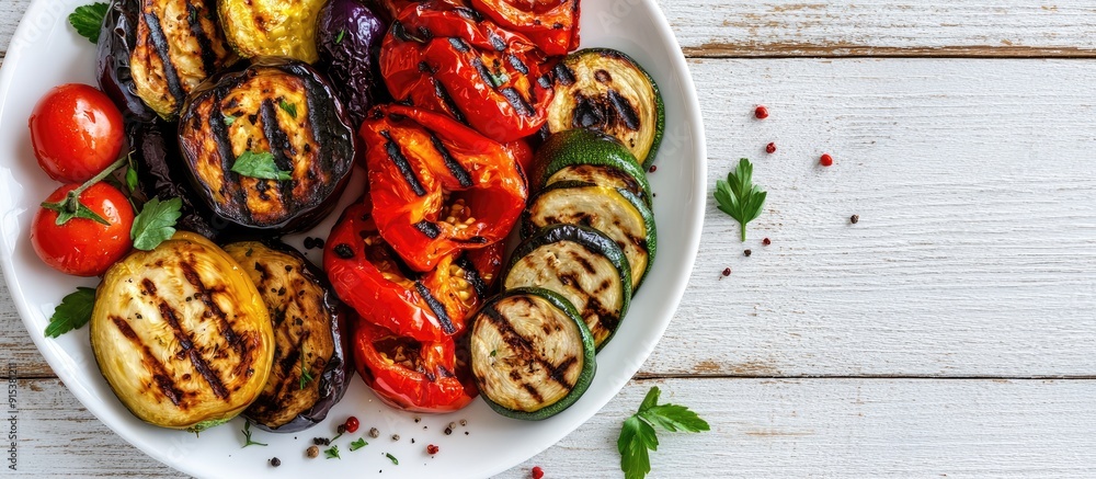 Close up of grilled vegetables on a white plate placed on a white wooden table Tomato pepper eggplant zucchini and onion cooked over charcoal Copy space image for barbecue Healthy food Close up of grilled vegetables on a white plate placed on a white wooden table Tomato pepper eggplant zucchini and onion cooked over charcoal Copy space image for barbecue Healthy food