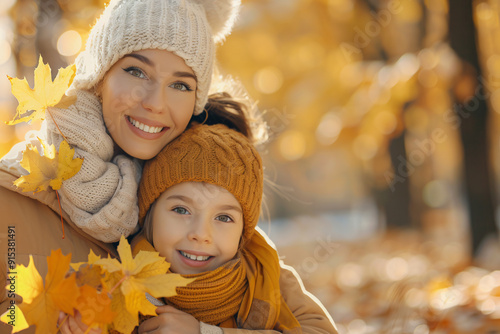 mother and daughter with yellow leaves in autumn park