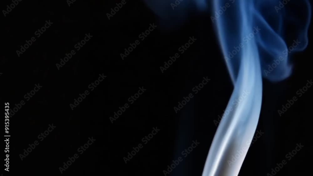Wisp of smoke floating gently through a black background Wisp of smoke floating gently through a black background
