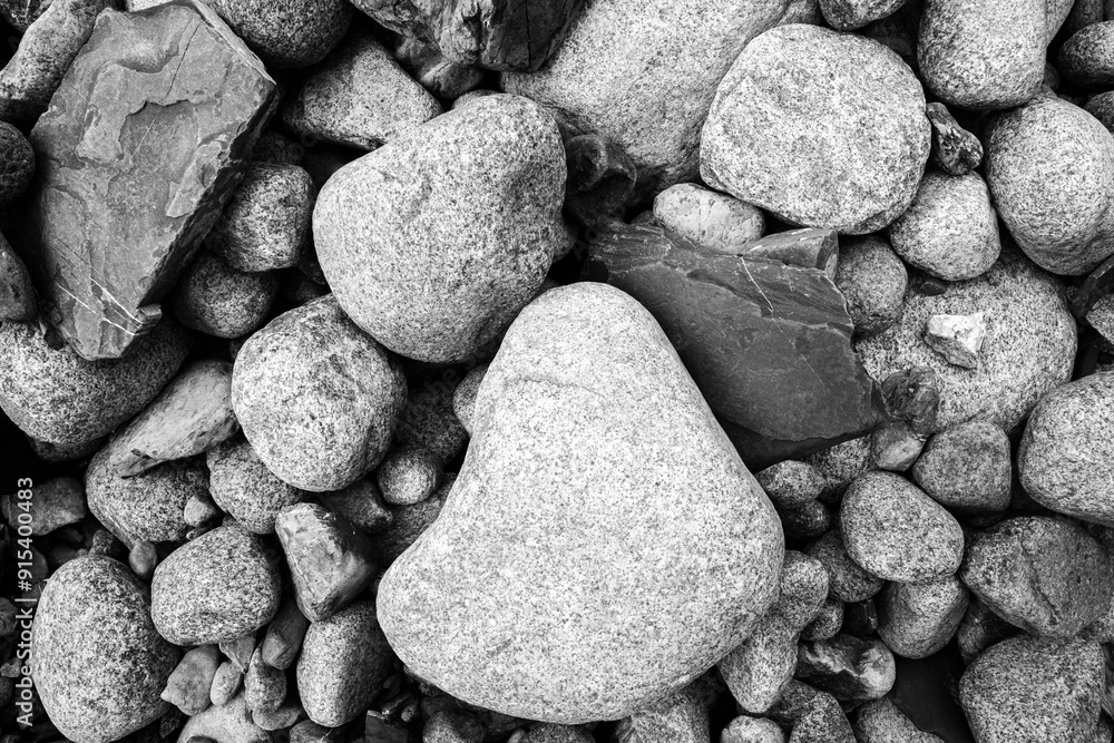A monochromatic close-up of an assortment of rounded stones creates a textured mosaic of natural elements.
A monochromatic close-up of an assortment of rounded stones creates a textured mosaic of natural elements.