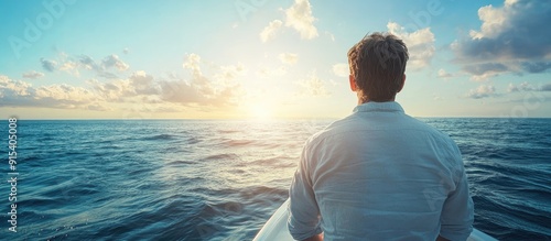 Man gazing at the ocean from a boat The back view of a man at the boat s edge observing the seascape. with copy space image. Place for adding text or design photo