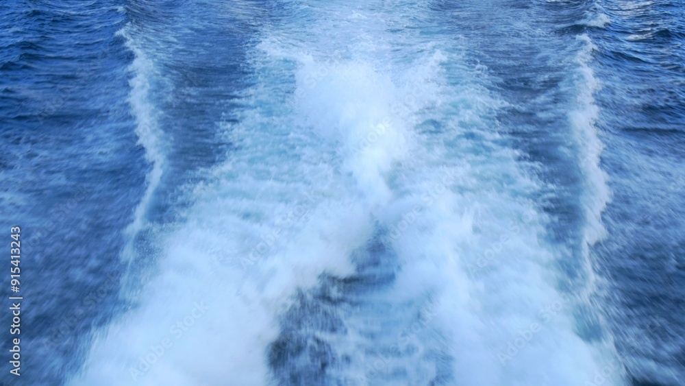 Dynamic waves created by moving boat, illustrating power and beauty of ...