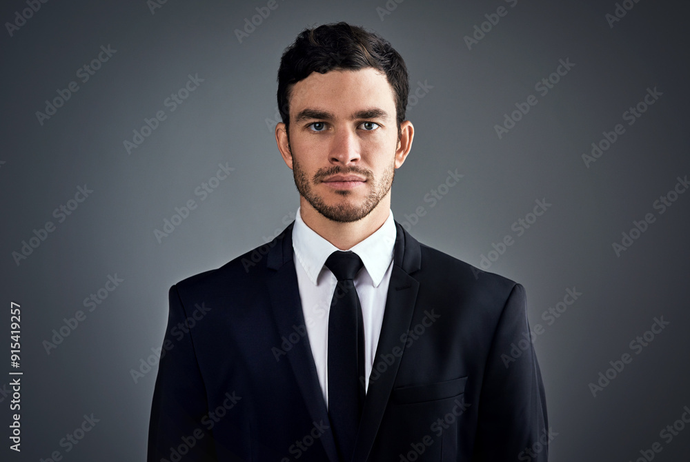 Business, man and portrait in studio for fashion or office wear with confidence on grey background. Male person, entrepreneur and serious with suit as accountant for career growth job opportunity Business, man and portrait in studio for fashion or office wear with confidence on grey background. Male person, entrepreneur and serious with suit as accountant for career growth job opportunity