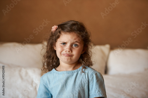 Photos Home, portrait and kid with silly face in bedroom for playful humor, joke and funny expression