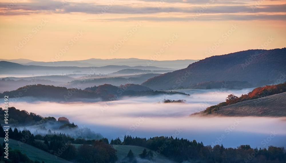 Fog rolling over a valley at dawn Fog rolling over a valley at dawn