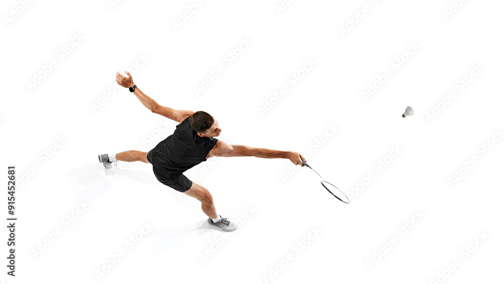 Focused and motivated man, badminton player training, playing with intensity and determination isolated on white background. Concept of sport, competition, active and healthy lifestyle Focused and motivated man, badminton player training, playing with intensity and determination isolated on white background. Concept of sport, competition, active and healthy lifestyle