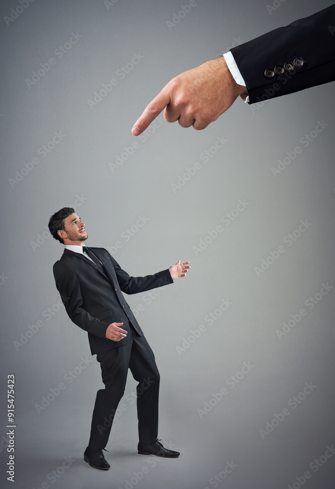 Business, man or small with pointing for warning, discipline or manipulation in studio. Corporate bullying, boss hand or male employee on gray background for accountability, responsibility or mistake Business, man or small with pointing for warning, discipline or manipulation in studio. Corporate bullying, boss hand or male employee on gray background for accountability, responsibility or mistake