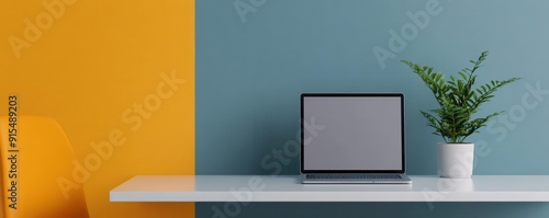 Wallpaper Mural Modern workspace with a laptop, plant, and colorful wall. Ideal for showcasing productivity and creativity in an office environment. Torontodigital.ca