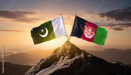 Pakistan and Afghanistan Flags Raised on a Mountain Peak at Sunrise