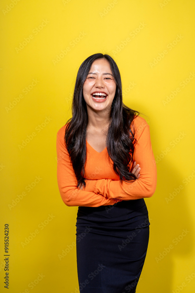 A woman in an orange shirt and black skirt is smiling and laughing A woman in an orange shirt and black skirt is smiling and laughing