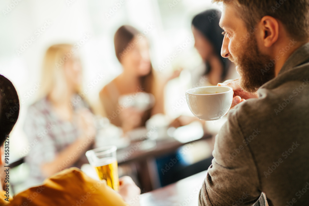 Group of friends socializing at a cafe Group of friends socializing at a cafe