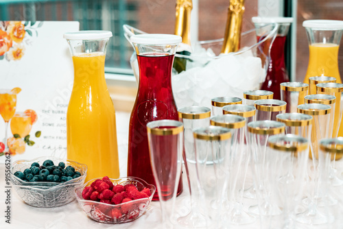 bright table with champagne, juice and fruit for mimosas