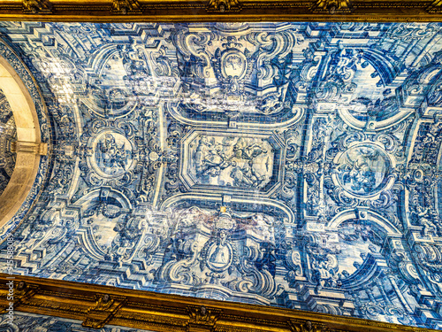 Main altar of Igreja de Sao Lourenco church in Almancil, Portugal, with religious sculptures and azulejos.