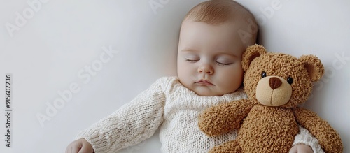 A baby sleeps with a teddy ...