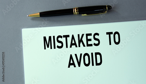 MISTAKES TO AVOID - words on a piece of paper with a pen on a gray background