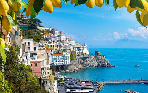 Stunning view of Amalfi, Italy, with colorful houses, clear blue waters of Mediterranean Sea and vibrant lemons in foreground. Amalfi coast is most popular travel and holiday destination in Europe photo