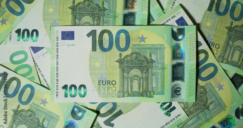 One hundred euro bills are randomly lying on the table. View from above One hundred euro bills are randomly lying on the table. View from above