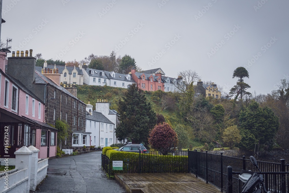 Picturesque view of colorful houses on a hillside in Portree, Isle of Skye, Scotland on a cloudy day Picturesque view of colorful houses on a hillside in Portree, Isle of Skye, Scotland on a cloudy day