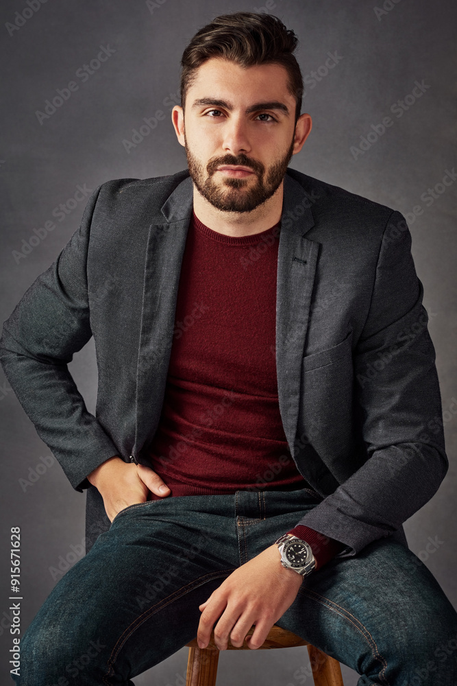 Portrait, man and confident on stool in studio with casual clothes, trendy fashion and suit jacket as real estate agent. Business, person and chair for investment, property advice and grey background Portrait, man and confident on stool in studio with casual clothes, trendy fashion and suit jacket as real estate agent. Business, person and chair for investment, property advice and grey background