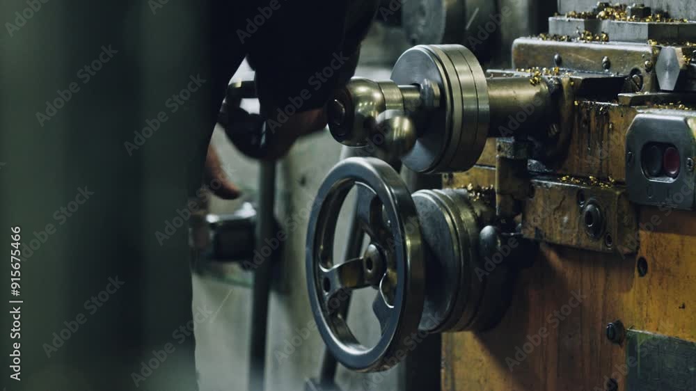 Skilled worker showcasing precision and craftsmanship on a metal lathe in a manufacturing workshop. Turning wheels and adjusting settings with expertise Skilled worker showcasing precision and craftsmanship on a metal lathe in a manufacturing workshop. Turning wheels and adjusting settings with expertise