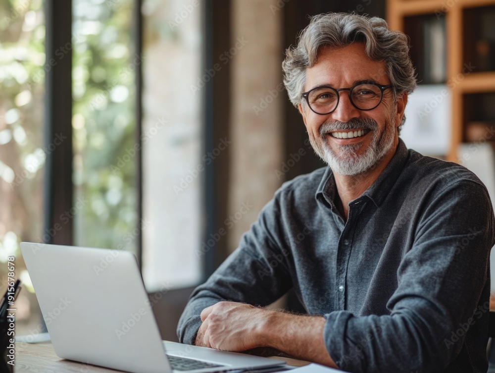A person sitting at home or office using a laptop for work or personal activities A person sitting at home or office using a laptop for work or personal activities