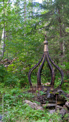 Radon source of holy and miraculous water of Platonida in forest near Mount Shunut or Shunut-Kamen in Sverdlovsk region of Russia, west of Yekaterinburg. Vertical image photo