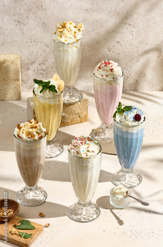 Assorted Milkshakes in Glasses - Delicious Beverages with Whipped Cream and Toppings photo