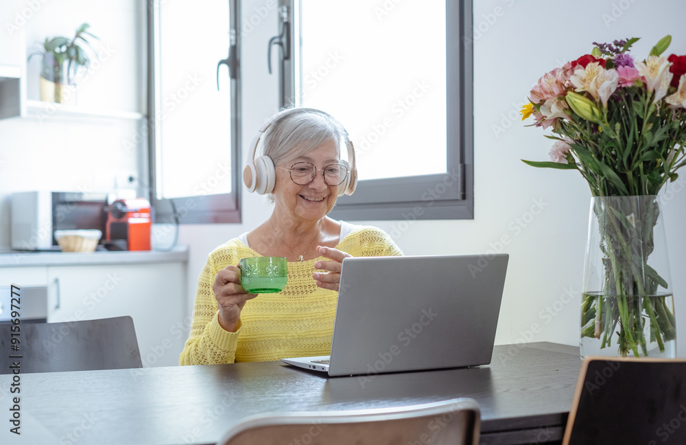 Video call concept. Senior caucasian woman smiling working online on laptop, learning education course, conference calling sit at home desk, remote working Video call concept. Senior caucasian woman smiling working online on laptop, learning education course, conference calling sit at home desk, remote working