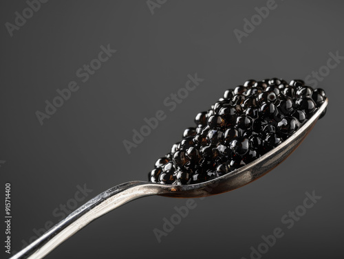 A Silver Spoon Filled with Black Caviar