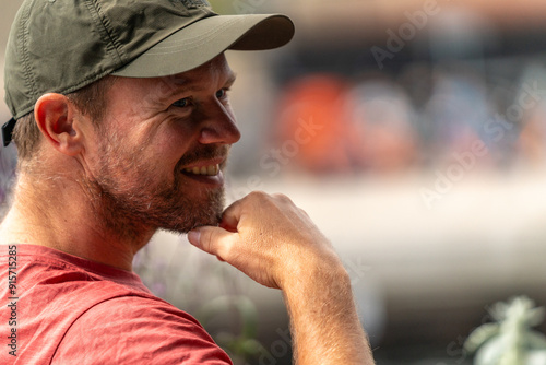 Photography blond man traveler siting in cafe in copenhagen enjoying cafe and admiring the c