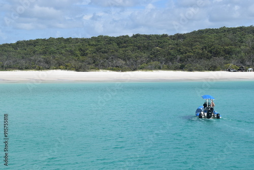 Sailing on the crystal clear turqoise blue water around the white sand beaches of Fraser Island in Queensland, Australia photo