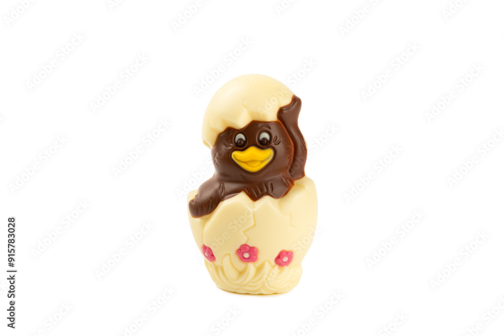 Obraz premium Easter Chocolate Chick isolated on white background. Easter celebration concept. Happy Easter. Chocolate sweet eggs. Candies on textured table. Space for text.Copy space