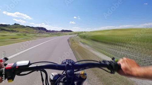 POV timelapse Electric Bike Riding on a Winding Asphalt Road in Small Mountain Area at Sunny Summer Day. 60 fps, H.264, 8bit, Chroma Subsamlping 4:4:4