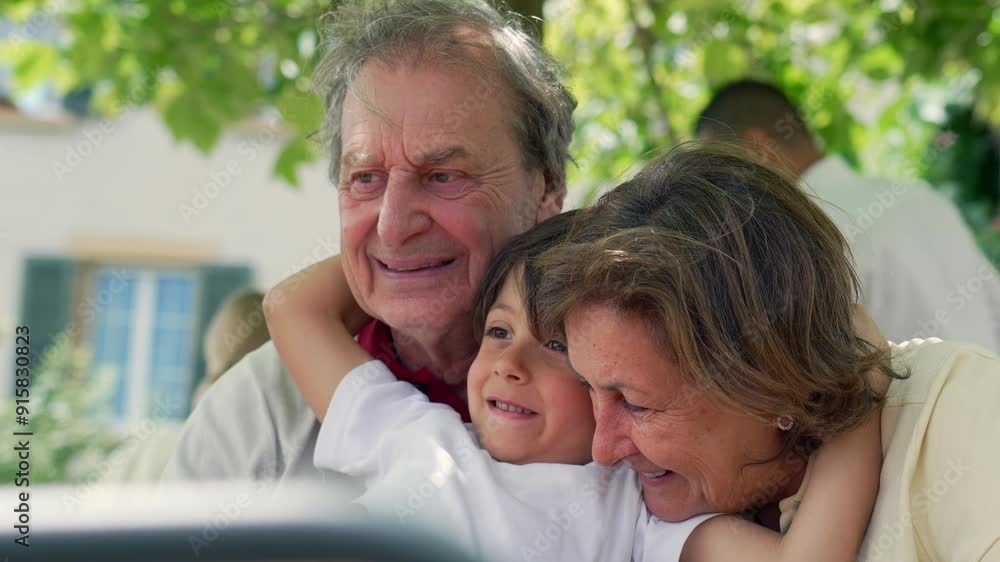 Happy grandparents and their young grandson share a warm embrace at an outdoor cafe, smiling brightly, surrounded by lush greenery, enjoying a beautiful sunny day together Happy grandparents and their young grandson share a warm embrace at an outdoor cafe, smiling brightly, surrounded by lush greenery, enjoying a beautiful sunny day together