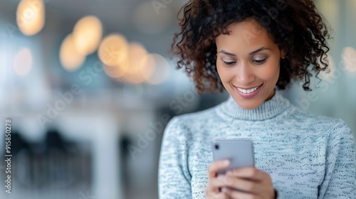 Woman Checking Phone While Snow Falls in Urban Area During Winter