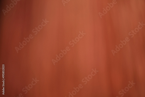 Blurred image of red leaves in spring, red wall